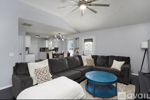 A living room with a grey couch and a blue coffee table.