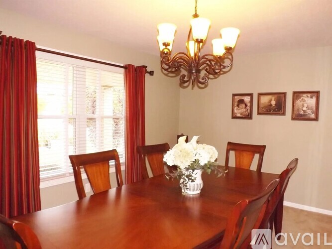 A dining room with a wooden table and chairs.