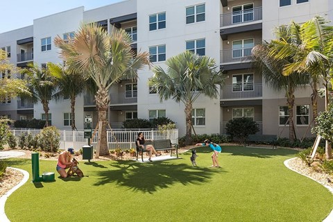 A large white building with a pool in the middle of it.