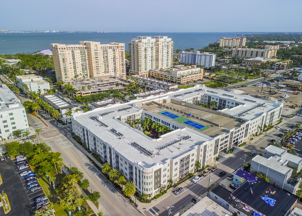 A large white building with a pool in the middle of it.
