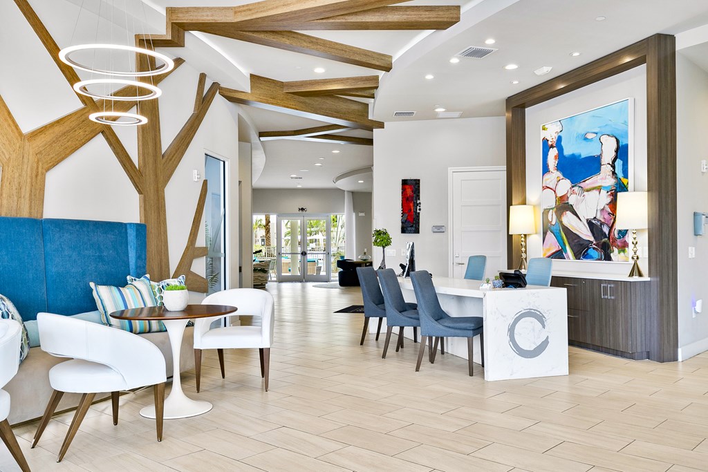 A modern office space with a reception desk and chairs.