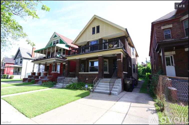 A house with a red roof and a balcony.