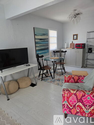 A living room with a red and white patterned chair in the foreground.