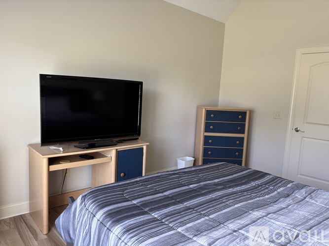 A white wall with a wooden shelf above it.