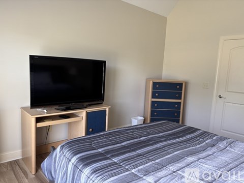 A white wall with a wooden shelf above it.
