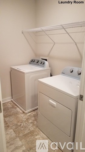 A bathroom with a toilet, a shower curtain, and a counter.