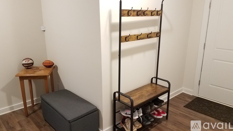 A shoe rack with several pairs of shoes and a bench with a cushion.