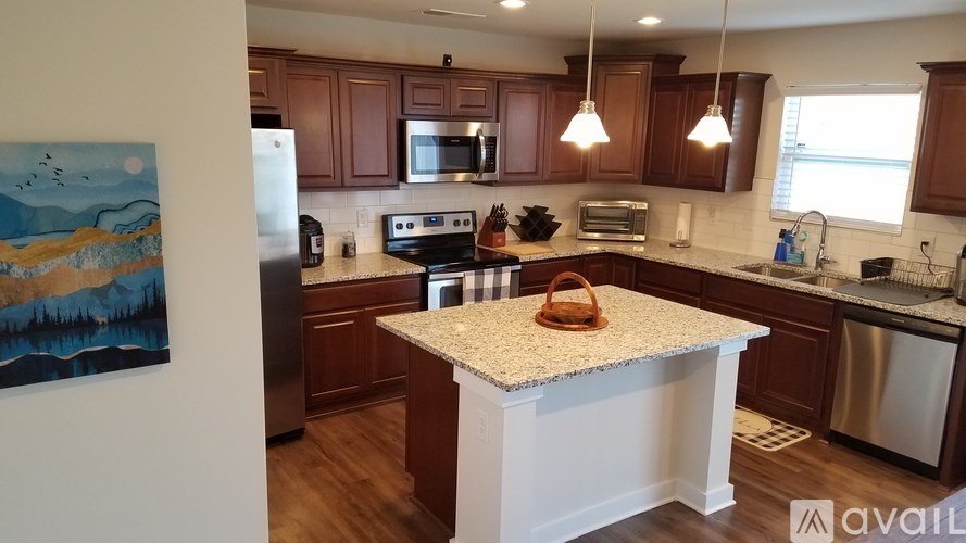 A kitchen with wooden cabinets and a granite countertop.