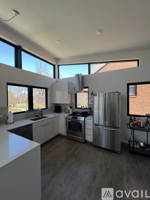 A modern kitchen with stainless steel appliances and a large island.