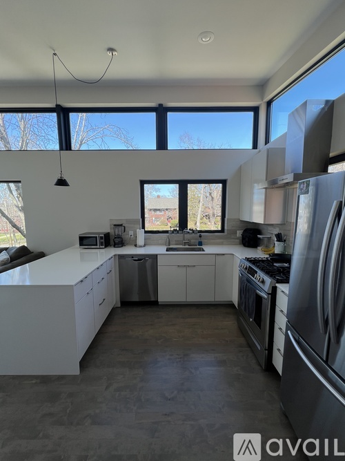 A modern kitchen with a large island and stainless steel appliances.