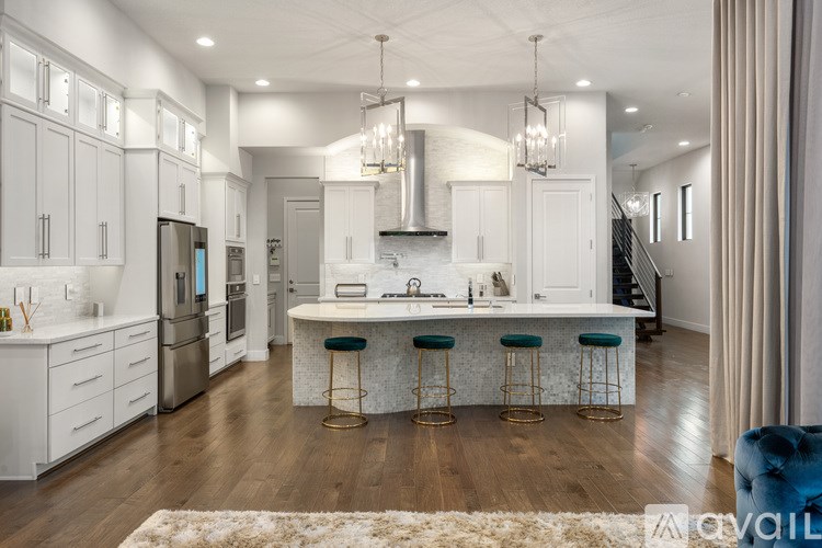 A modern kitchen with white cabinets and a central island.