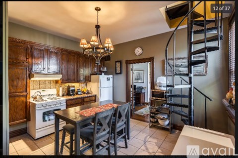 A kitchen with a table and chairs in the middle of it.