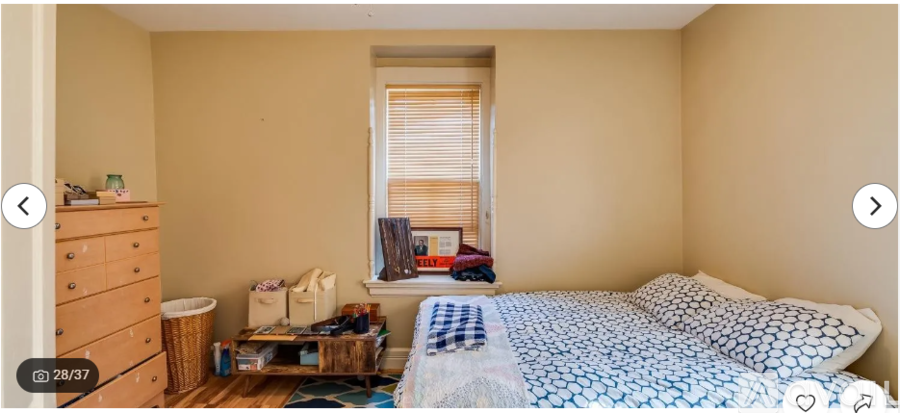 A bedroom with a bed, dresser, and window.