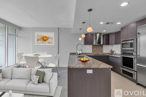 A modern kitchen with a dining table and chairs.