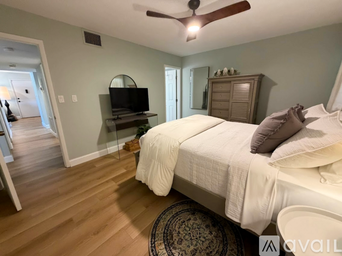 A kitchen with a sink and a fan.