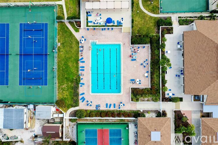 An aerial view of a pool and tennis courts.