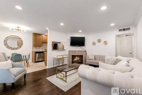 A living room with a fireplace and a television mounted on the wall.