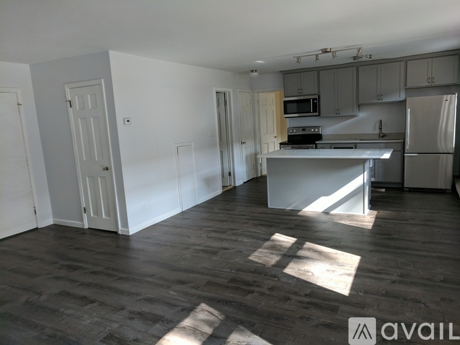 A kitchen area with a refrigerator, microwave, and oven.