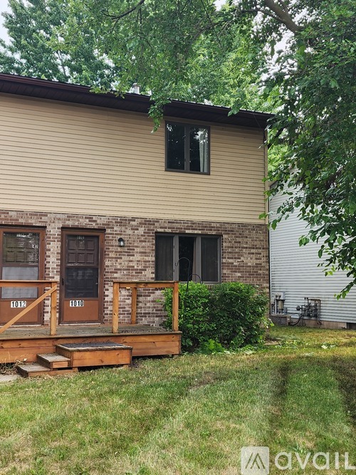 A house with a brown door and a porch.