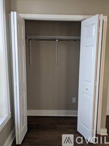 A white closet with a shelf and rod.