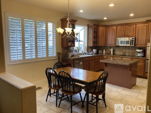 A kitchen with a table and chairs.