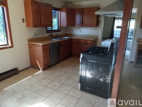 A kitchen with a black stove top oven.