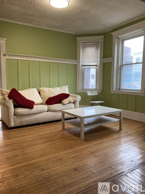 A living room with a white couch and a coffee table.