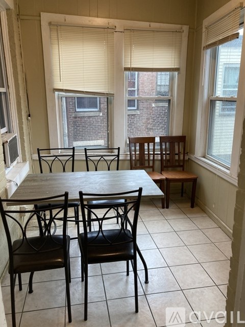 A dining room with a table and chairs.