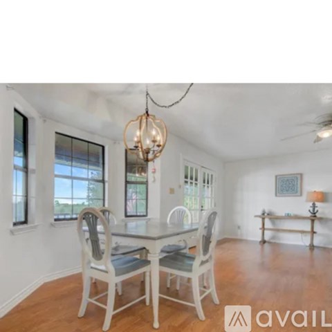 A living room with a dining table and chairs.