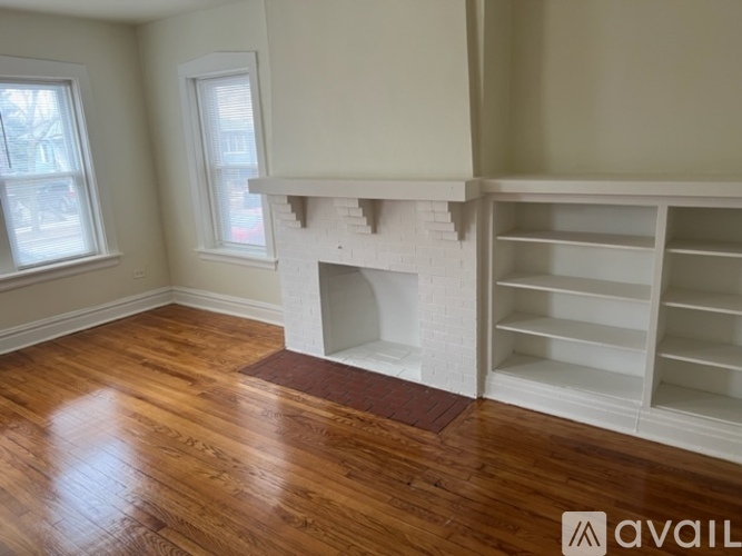 A room with a fireplace and wooden floors.