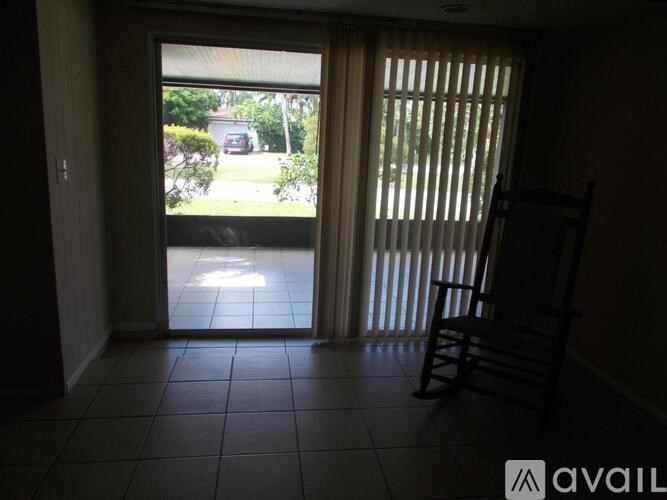A room with a tiled floor and a chair is shown.