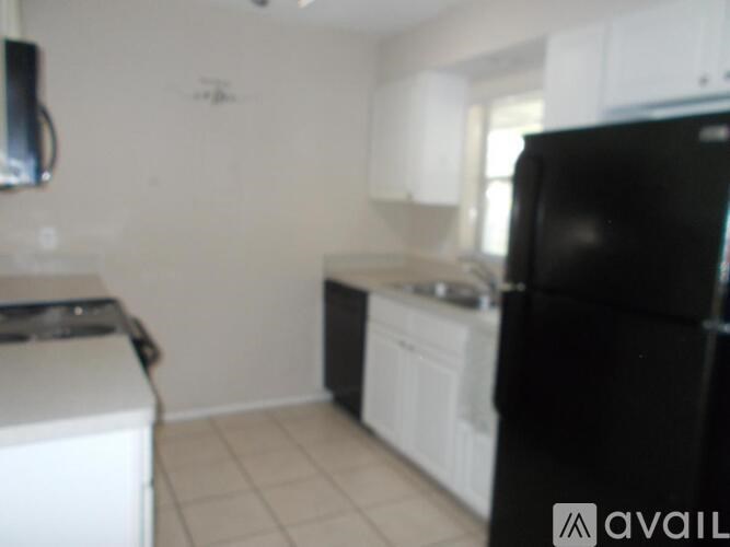 A black refrigerator is in the kitchen.