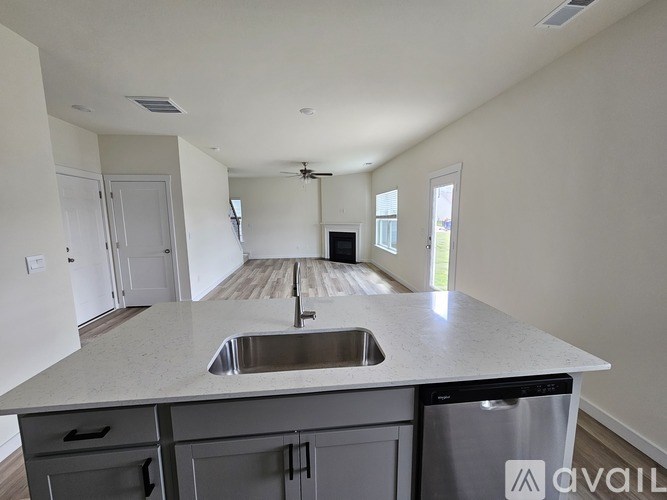 A small, empty room with a shelf and a wooden floor.