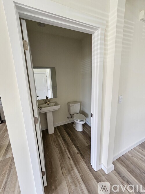 A room with a white door and carpeted floor.