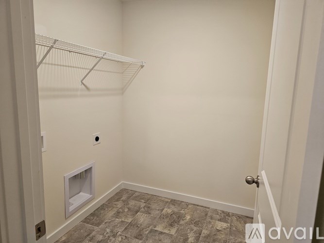 A small, empty room with a door and a window.