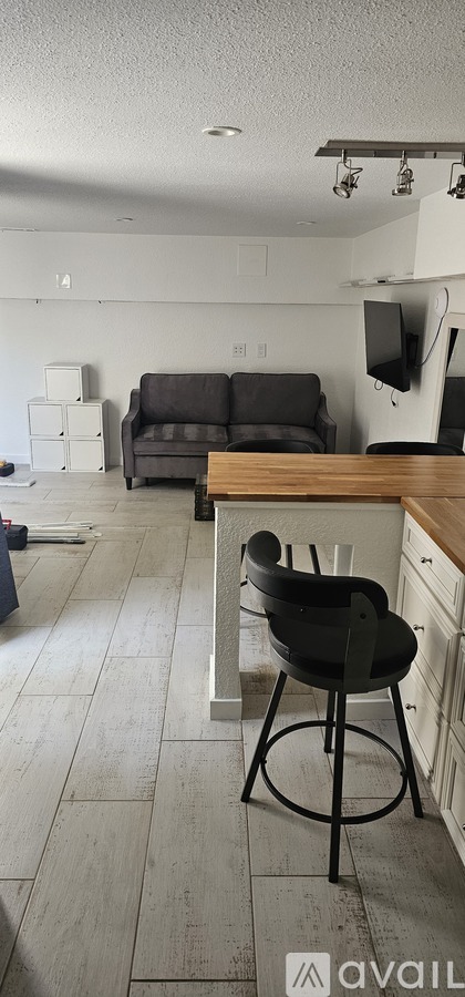 A kitchen with a bar stool and a counter.
