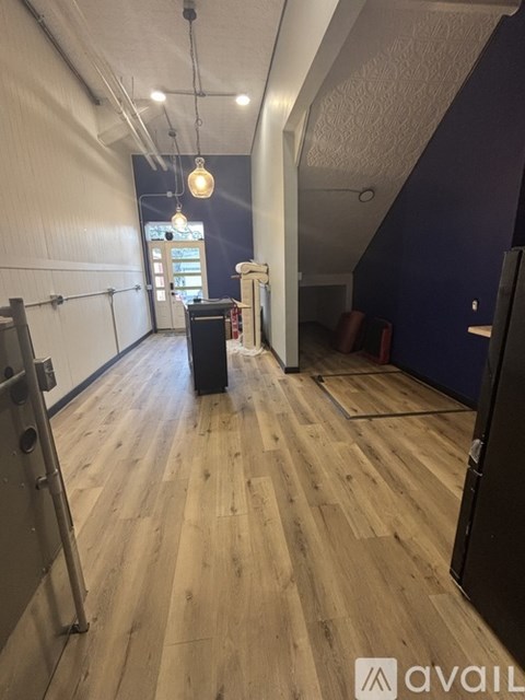 A room with wooden floors and a black speaker.