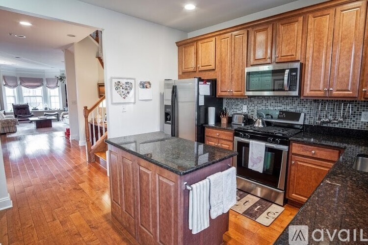 A kitchen with wooden cabinets and granite countertops.
