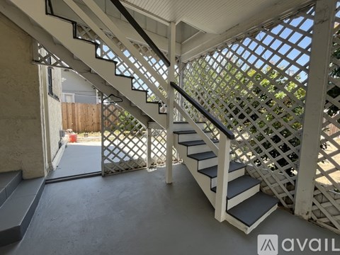 A staircase with a lattice design on the railing.