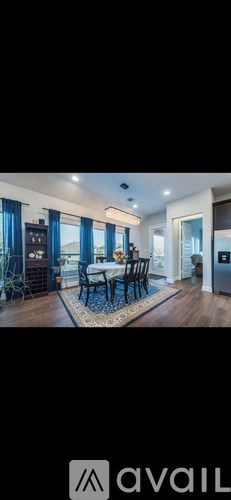 A modern living room with a dining table and chairs.