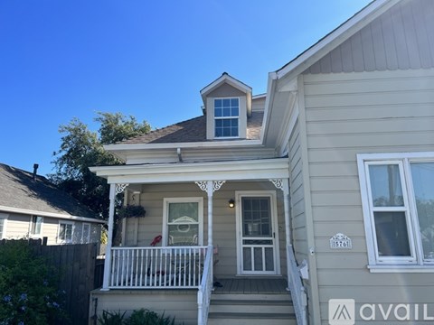 A house with a porch and a balcony is for sale.
