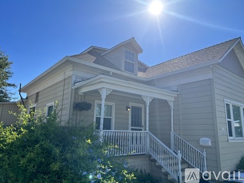 A house with a sunny sky above it.