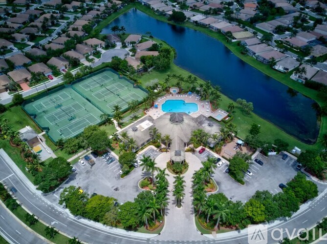 An aerial view of a neighborhood with a tennis court and a pool.