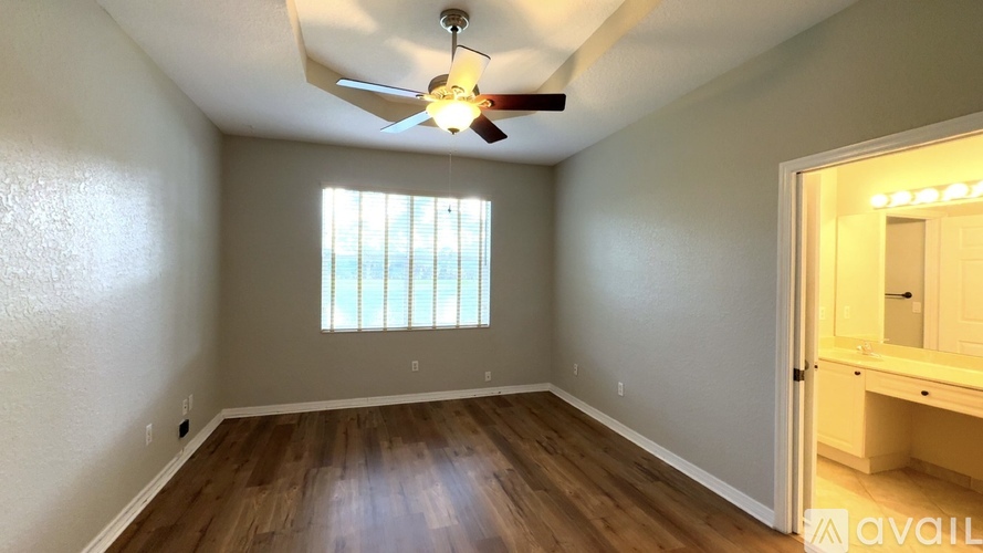 A living room with a flat screen TV and sliding glass doors.