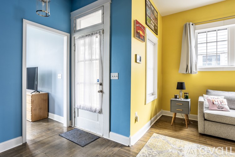 A living room with a blue wall and a white door.