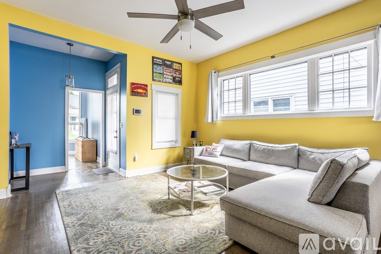 A living room with a grey couch and a coffee table.
