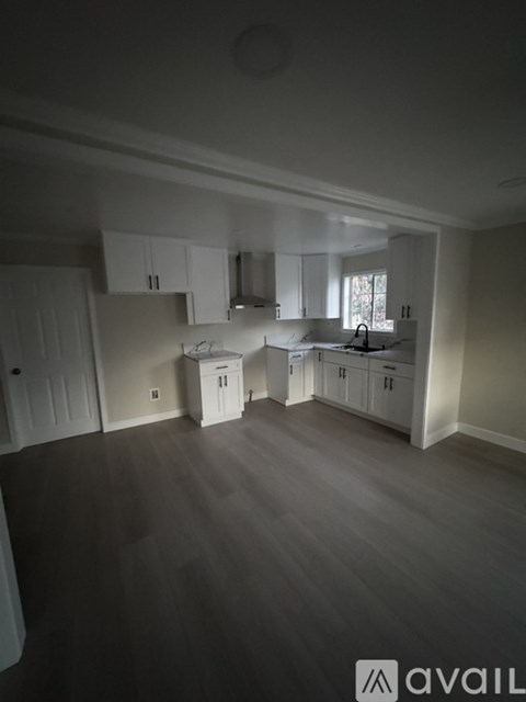 A kitchen area with cabinets and a countertop.