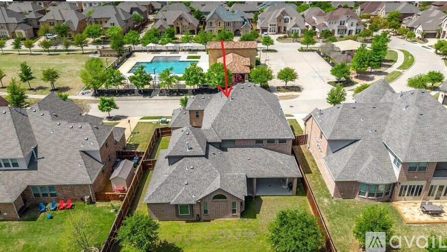 A bird's eye view of a neighborhood with houses and a pool.