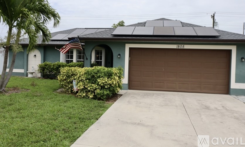 A house with a garage and a flag on the front.