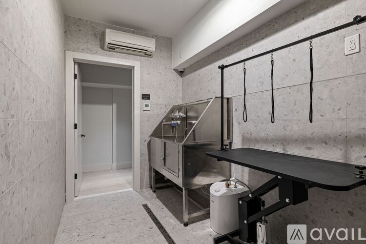 A room with a staircase and a wall-mounted air conditioner.